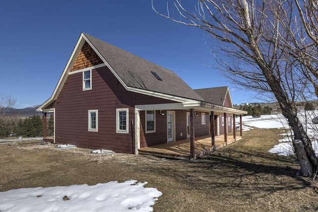 exterior space featuring a shingled roof