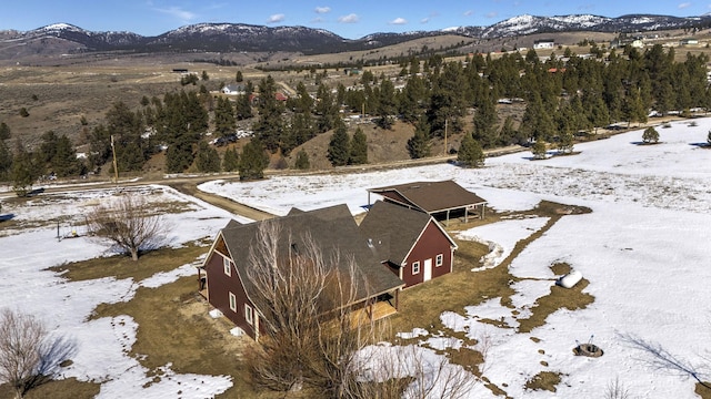 snowy aerial view featuring a mountain view