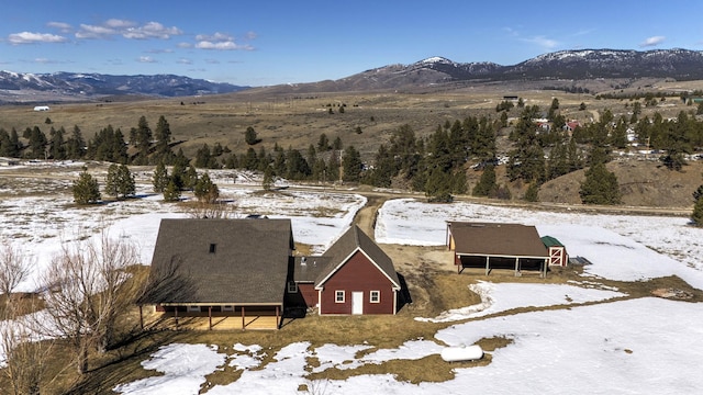 snowy aerial view with a mountain view