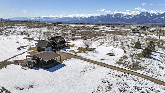 snowy aerial view with a mountain view