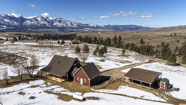 snowy aerial view featuring a mountain view