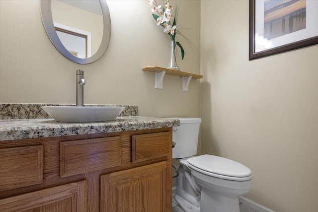 bathroom featuring toilet and vanity