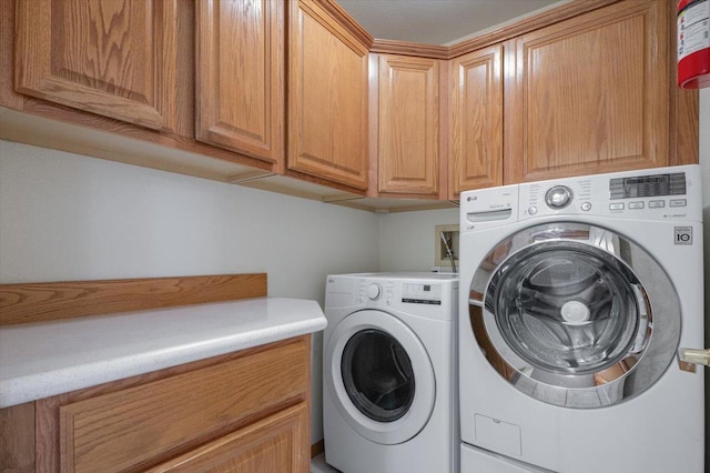 laundry area with cabinet space and separate washer and dryer