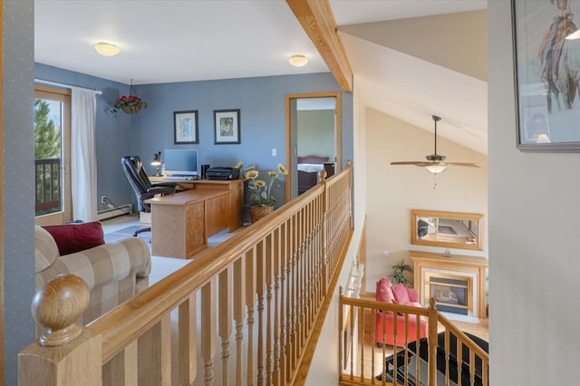 office with lofted ceiling with beams, a fireplace, and a baseboard radiator