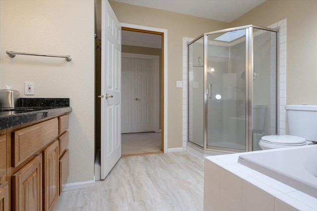 full bathroom featuring a stall shower, a relaxing tiled tub, and baseboards