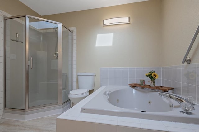 bathroom with toilet, a stall shower, a jetted tub, and wood finished floors