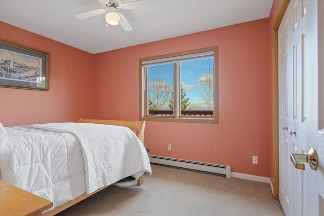 bedroom with carpet, baseboards, ceiling fan, a closet, and baseboard heating