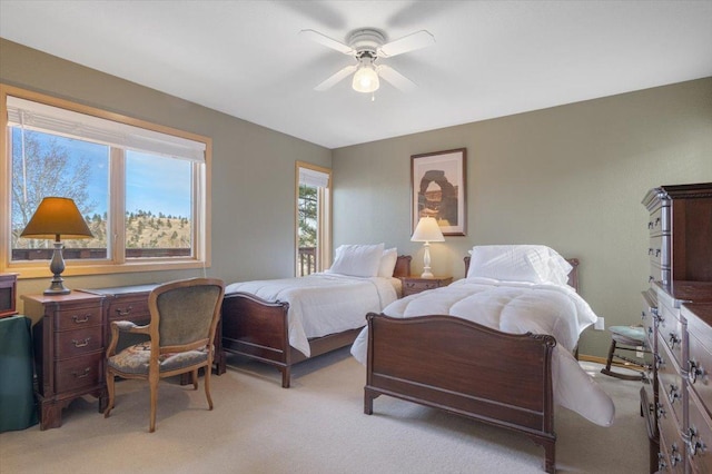 bedroom with light carpet and ceiling fan