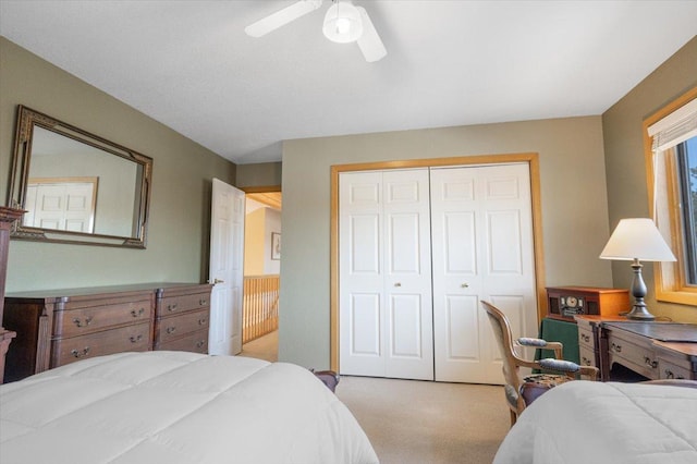 carpeted bedroom with a closet and ceiling fan