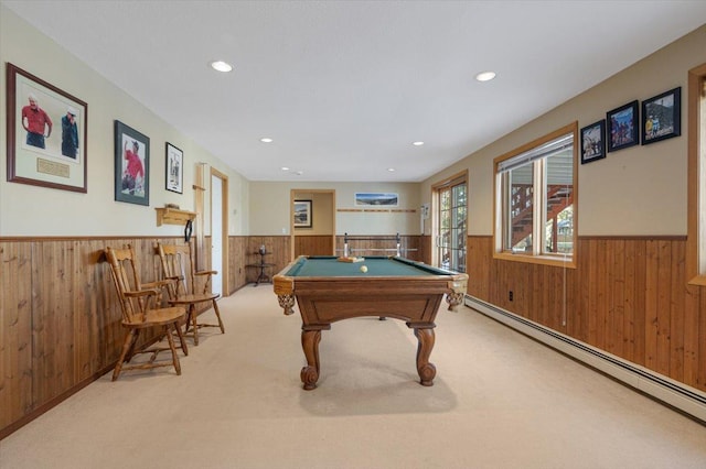 playroom with a baseboard heating unit, carpet flooring, wood walls, and wainscoting