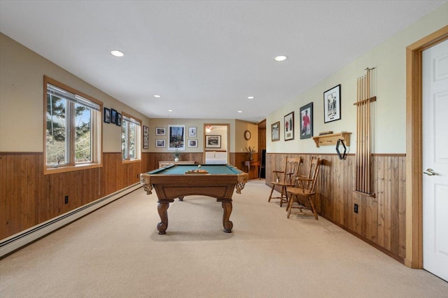 game room featuring wooden walls, baseboard heating, and wainscoting