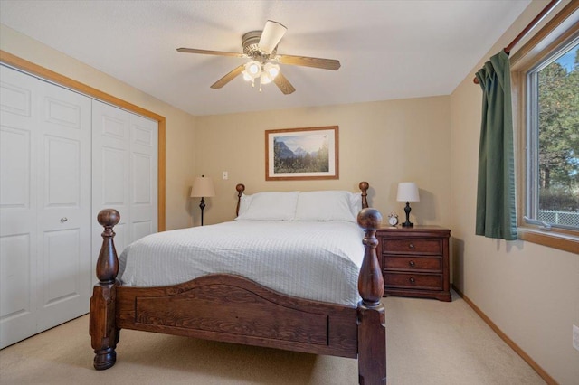 bedroom with a closet, carpet flooring, multiple windows, and baseboards