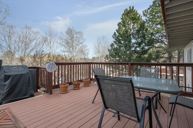 deck featuring outdoor dining space and area for grilling