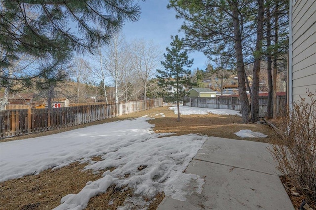 yard covered in snow featuring a fenced backyard