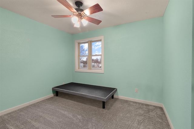 interior space with ceiling fan, baseboards, and carpet