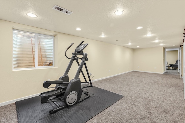 workout room with visible vents, baseboards, carpet, and a textured ceiling