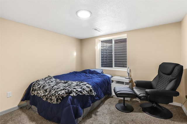 carpeted bedroom featuring baseboards, visible vents, and a textured ceiling