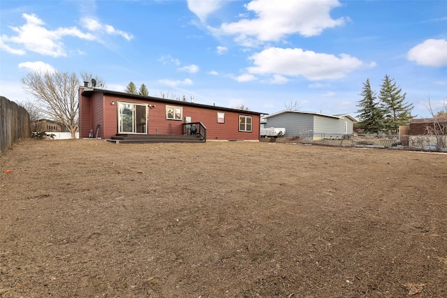 rear view of house featuring fence and a chimney