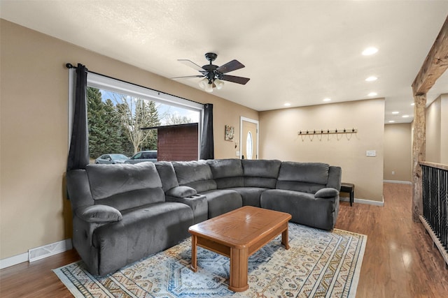 living area featuring recessed lighting, wood finished floors, and baseboards