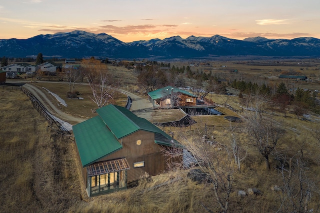 aerial view at dusk featuring a mountain view