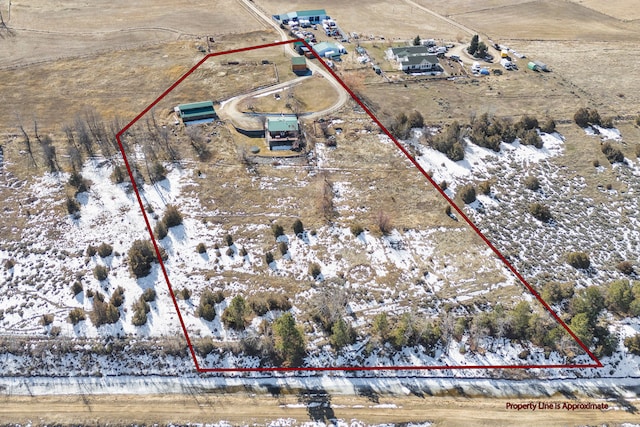 birds eye view of property with a rural view