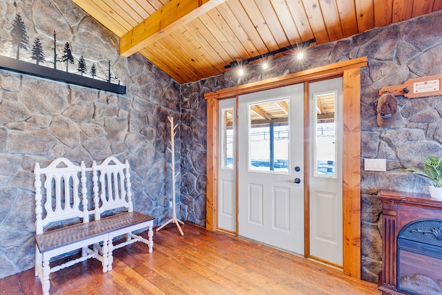 foyer featuring hardwood / wood-style floors, wooden ceiling, and lofted ceiling with beams