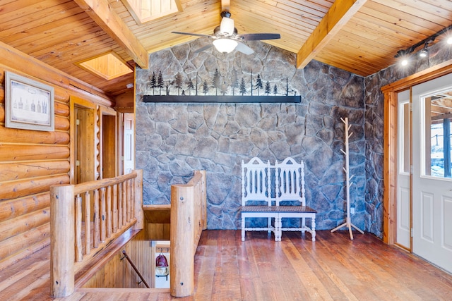 unfurnished bedroom with vaulted ceiling with skylight, wood ceiling, log walls, and hardwood / wood-style flooring