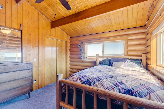 bedroom with log walls, multiple windows, wood ceiling, and vaulted ceiling with beams