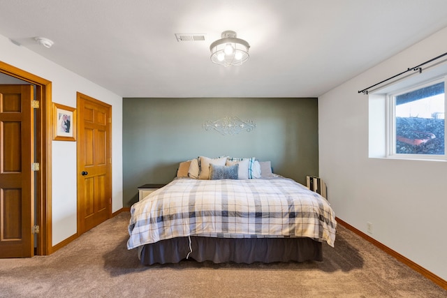 bedroom featuring baseboards, visible vents, and carpet floors