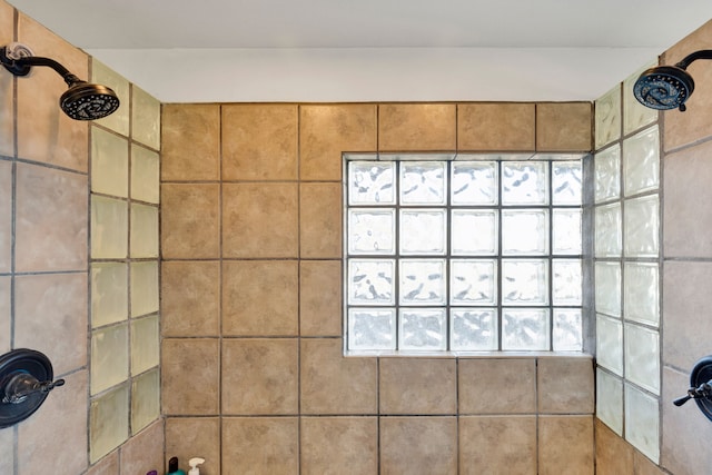 bathroom with a tile shower