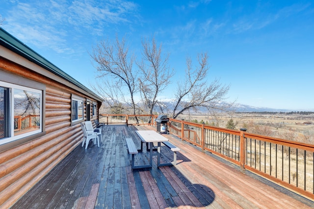 deck with area for grilling and a mountain view