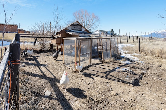 view of yard featuring exterior structure, an outdoor structure, and fence