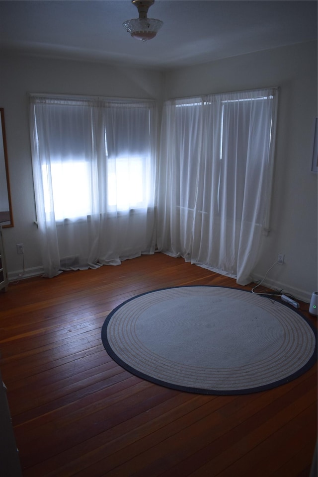 empty room with hardwood / wood-style flooring