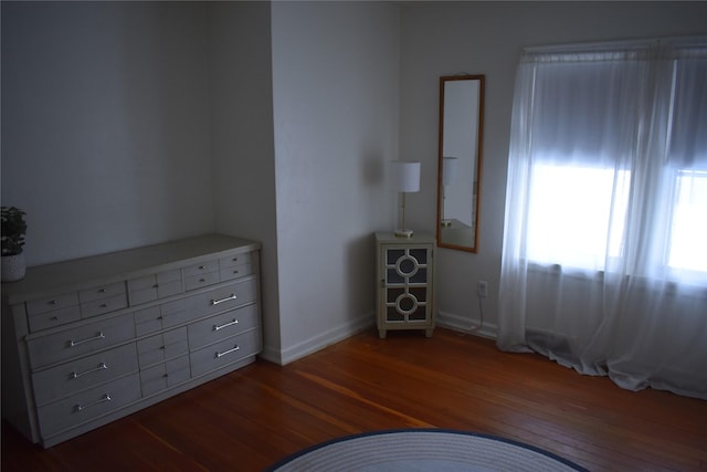 interior space featuring dark wood-style floors and baseboards