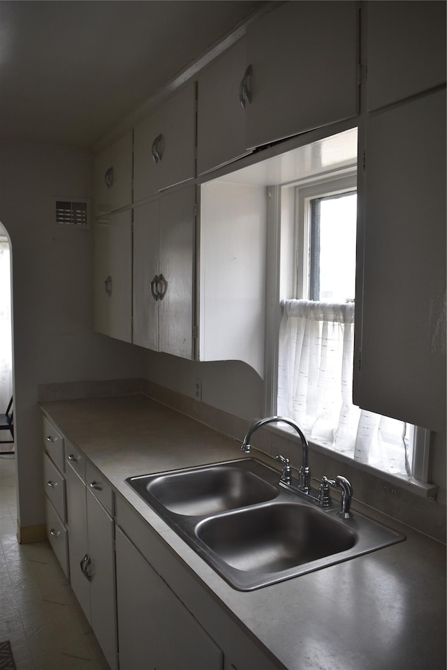 kitchen with a sink and visible vents