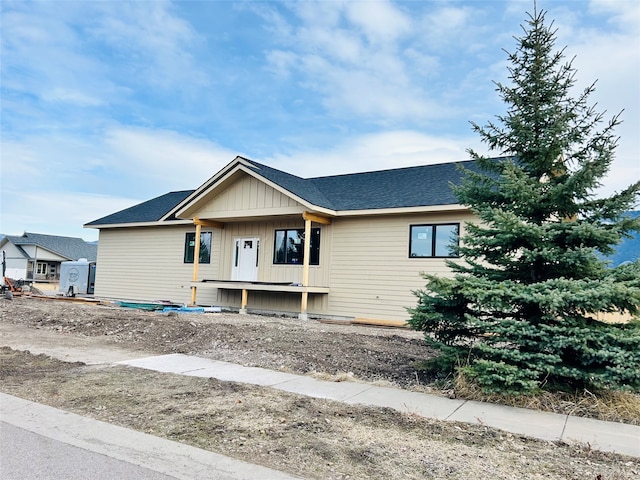 view of front of house featuring board and batten siding and a shingled roof