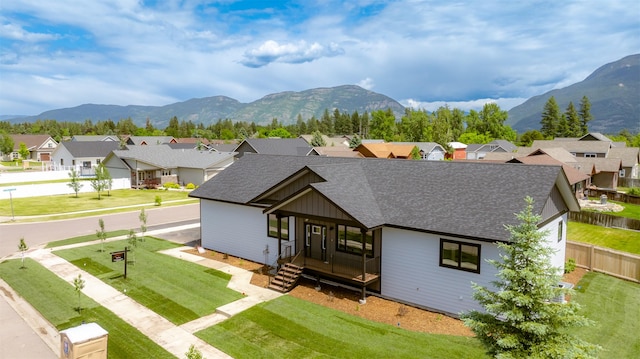 57 Hidden Cedar Loop, Columbia Falls, MT 59912 - view of front facade featuring a residential view, a shingled roof, a mountain view, and board and batten siding