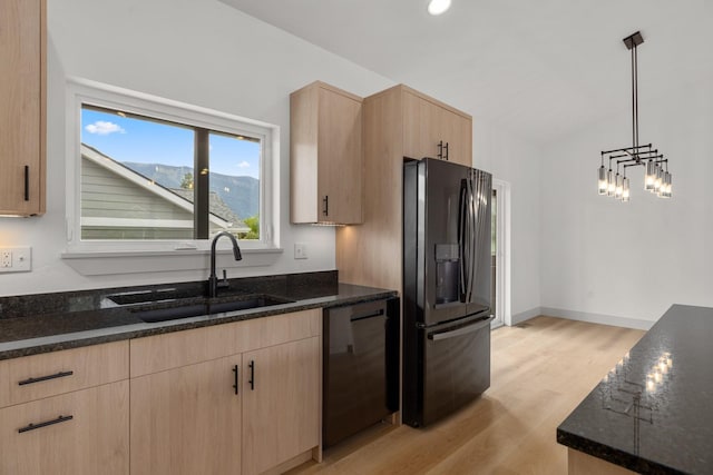 57 Hidden Cedar Loop, Columbia Falls, MT 59912 - kitchen featuring black fridge with ice dispenser, light brown cabinetry, dishwasher, and dark stone counters