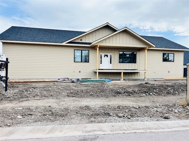 view of front facade featuring roof with shingles and board and batten siding