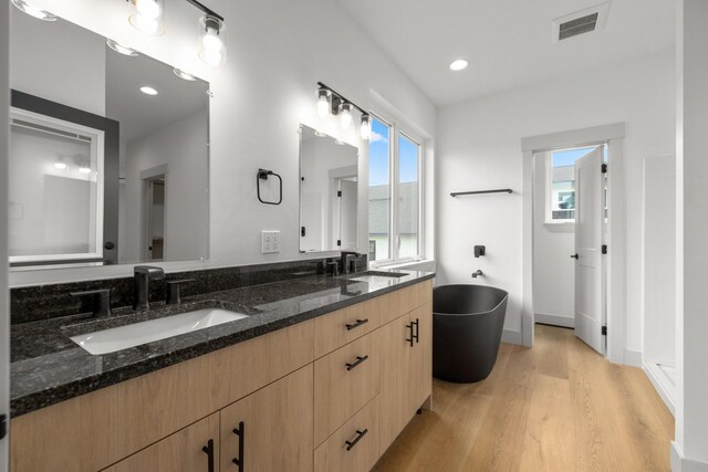 57 Hidden Cedar Loop, Columbia Falls, MT 59912 - full bath with a freestanding bath, double vanity, wood finished floors, and recessed lighting