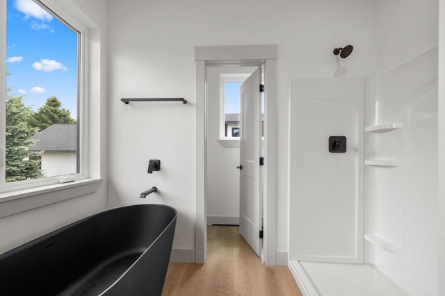 57 Hidden Cedar Loop, Columbia Falls, MT 59912 - full bathroom with wood finished floors, a soaking tub, and a shower