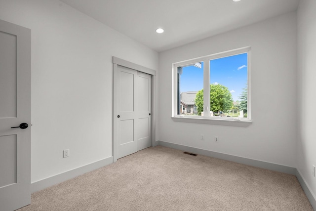 57 Hidden Cedar Loop, Columbia Falls, MT 59912 - unfurnished bedroom with light carpet and recessed lighting
