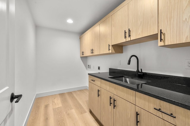 57 Hidden Cedar Loop, Columbia Falls, MT 59912 - kitchen featuring light brown cabinetry, dark stone countertops, light wood-type flooring, and recessed lighting