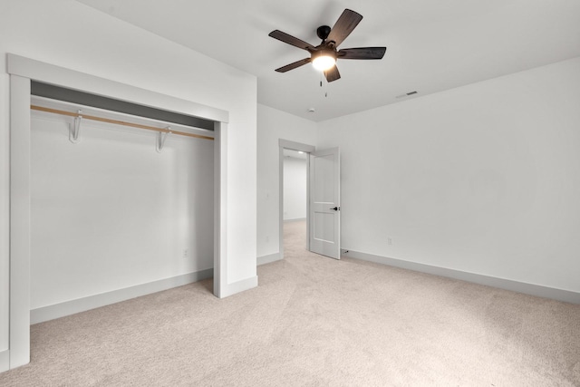 57 Hidden Cedar Loop, Columbia Falls, MT 59912 - unfurnished bedroom with carpet flooring, a closet, and a ceiling fan