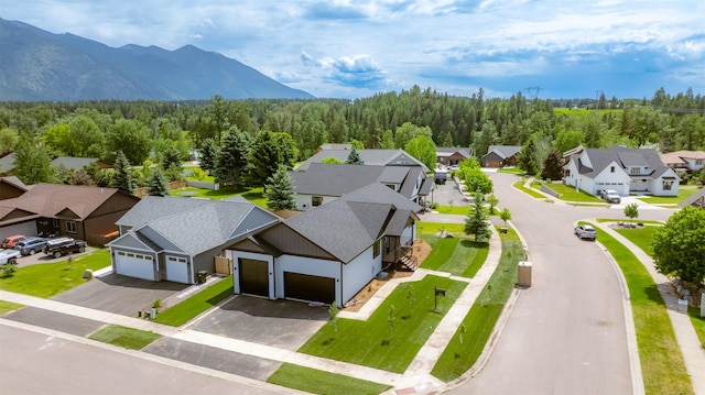 57 Hidden Cedar Loop, Columbia Falls, MT 59912 - aerial perspective of suburban area with a heavily wooded area and a mountain backdrop