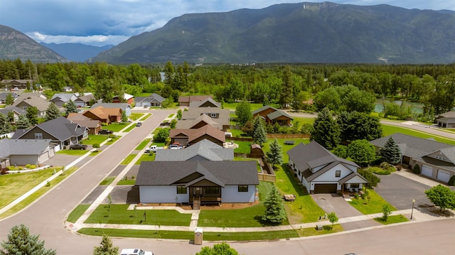 57 Hidden Cedar Loop, Columbia Falls, MT 59912 - aerial perspective of suburban area featuring a mountainous background and a forest