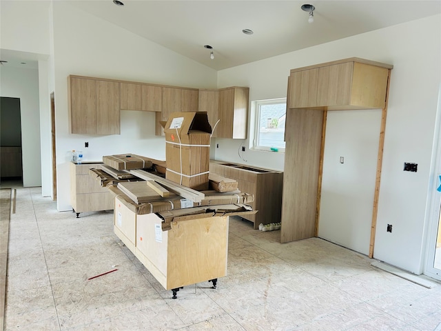 kitchen with a kitchen island, light brown cabinets, modern cabinets, and vaulted ceiling