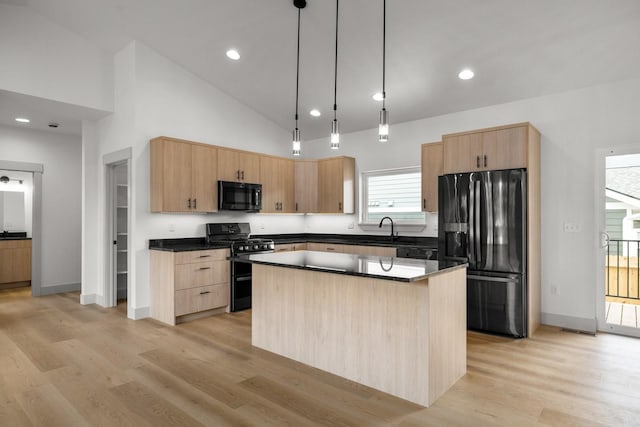 57 Hidden Cedar Loop, Columbia Falls, MT 59912 - kitchen featuring black appliances, light brown cabinets, dark countertops, light wood-style floors, and high vaulted ceiling