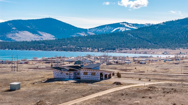 mountain view featuring a view of trees and a water view