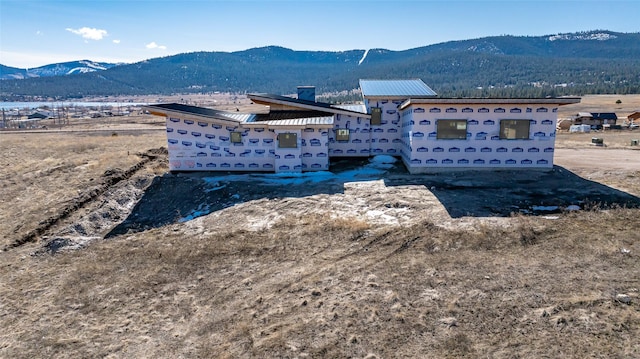 property under construction with a mountain view and metal roof